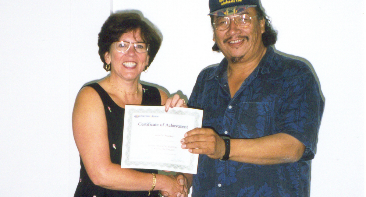 Three people sitting at a dais smiling